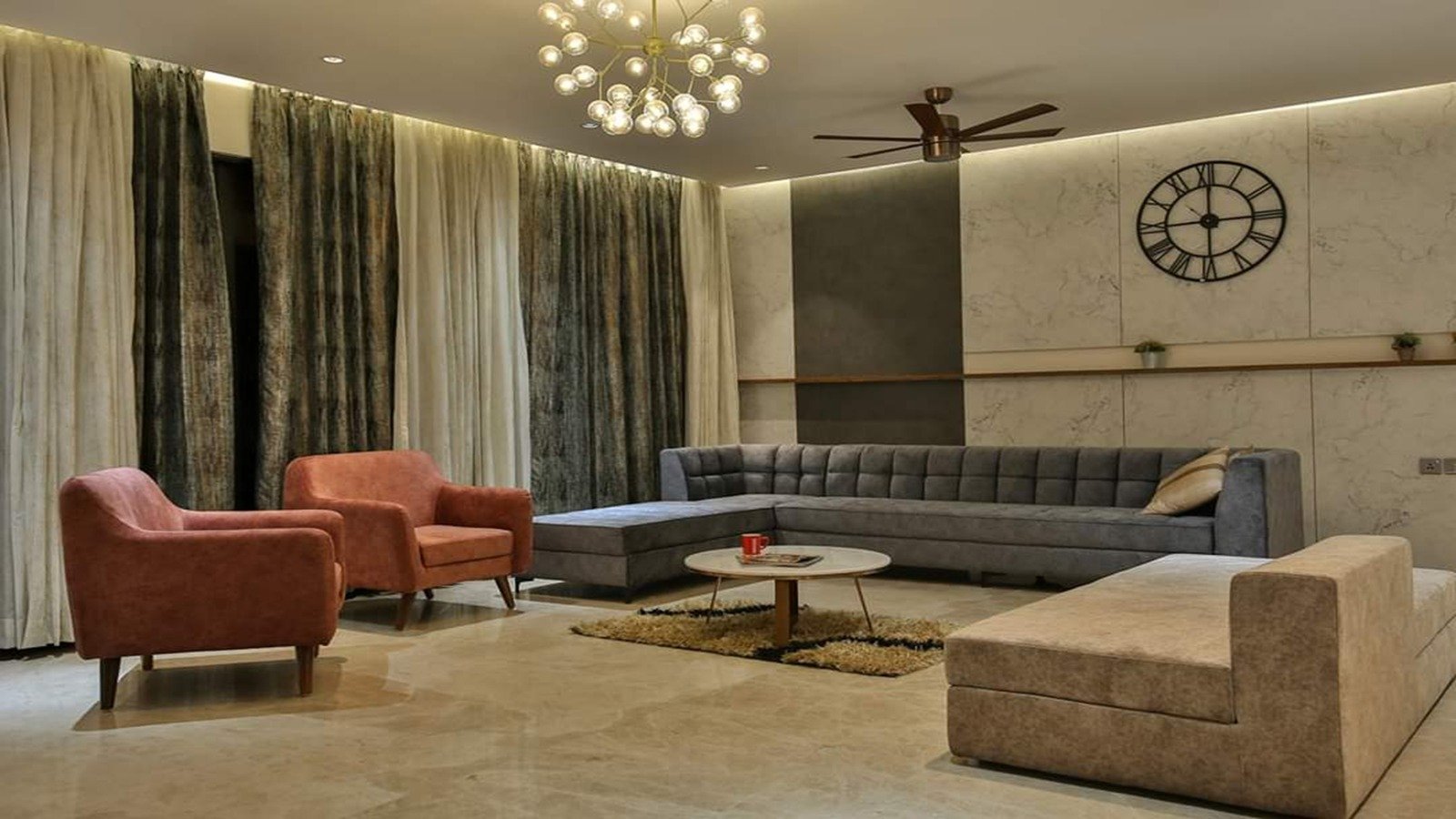Curved brown sofas under a sculptural ceiling