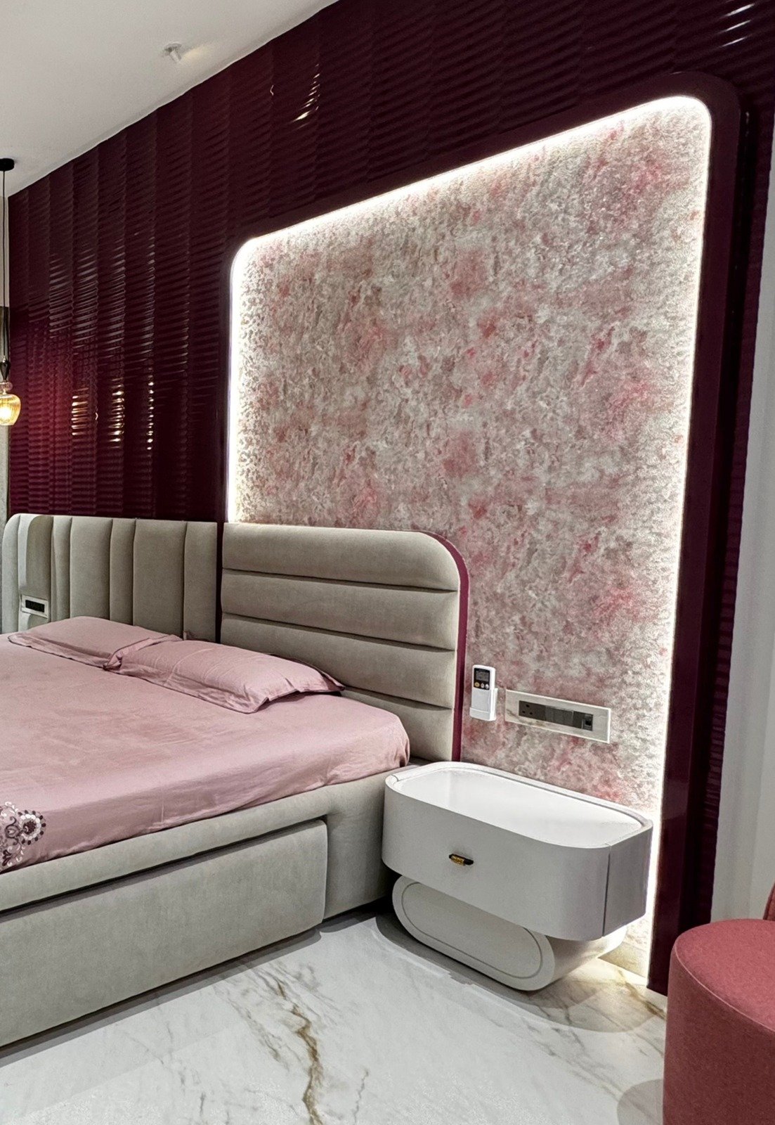 Backlit pink textured feature panel with maroon fluted panelling