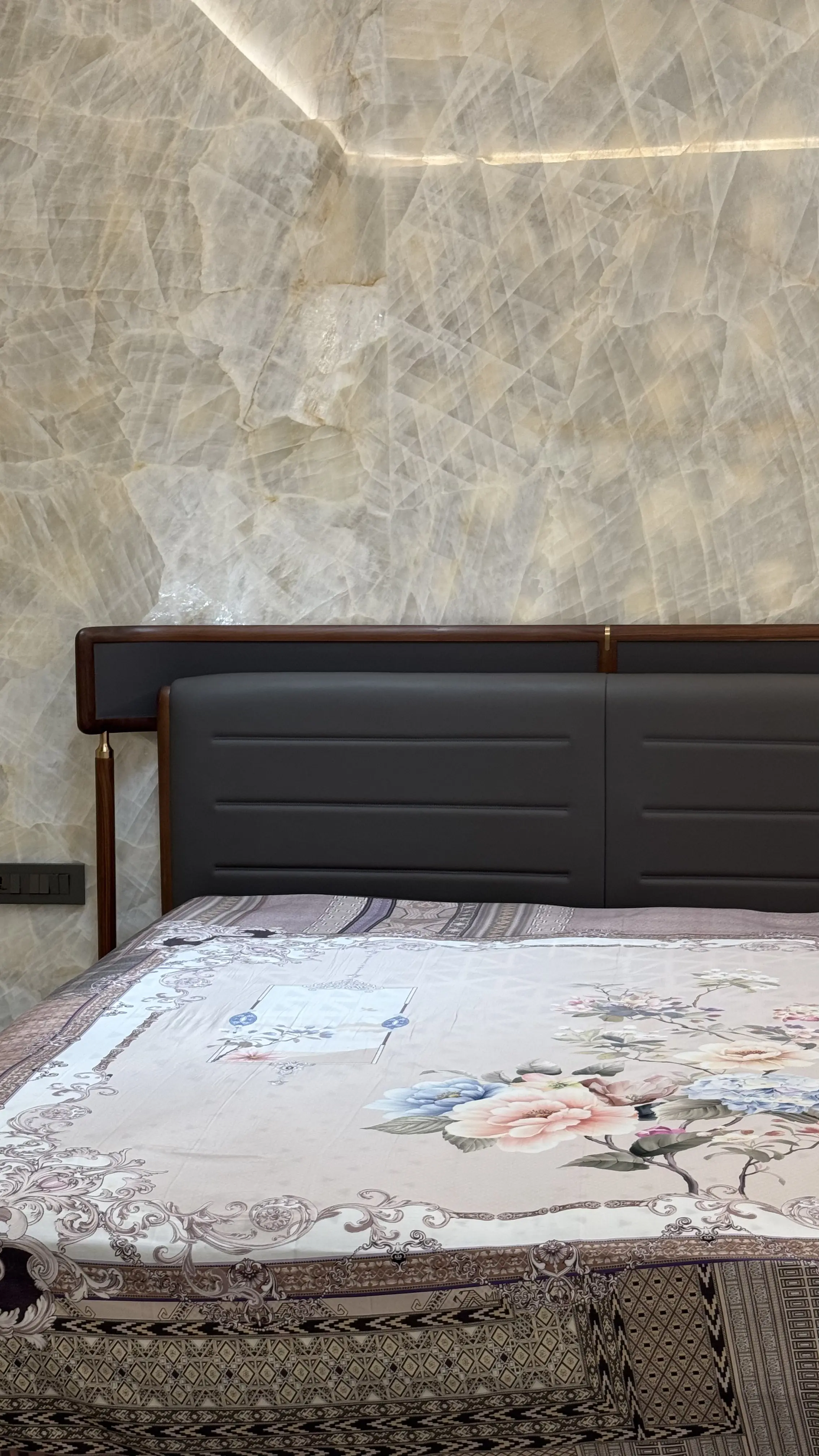 Upholstered bed back fitted in a finished bedroom