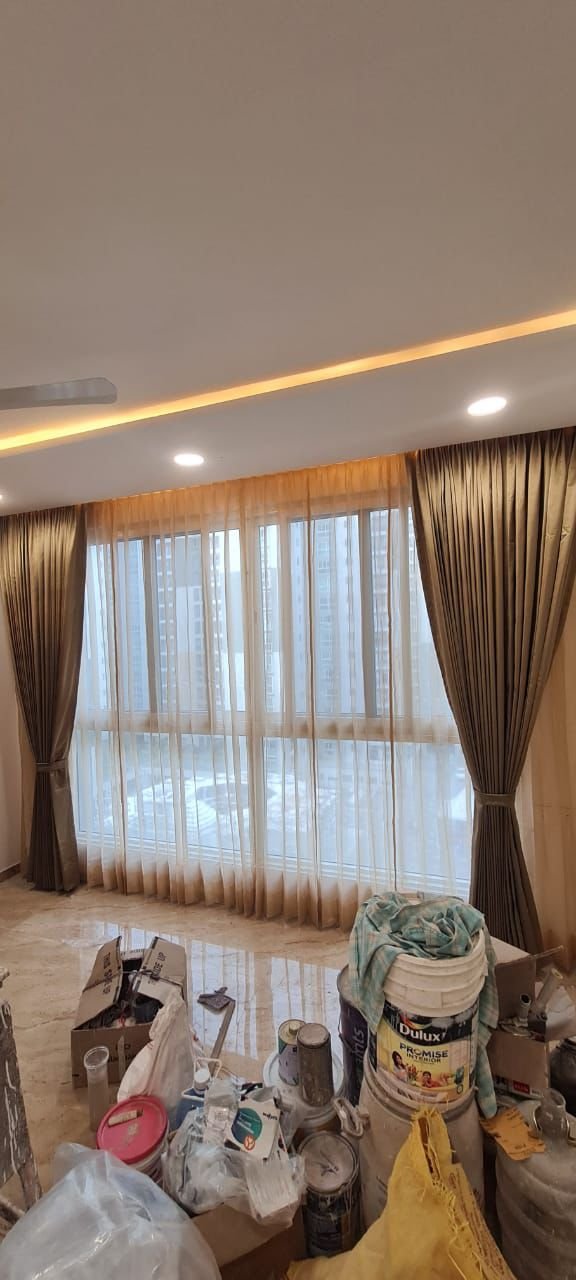 Brown and gold curtains on a wide window