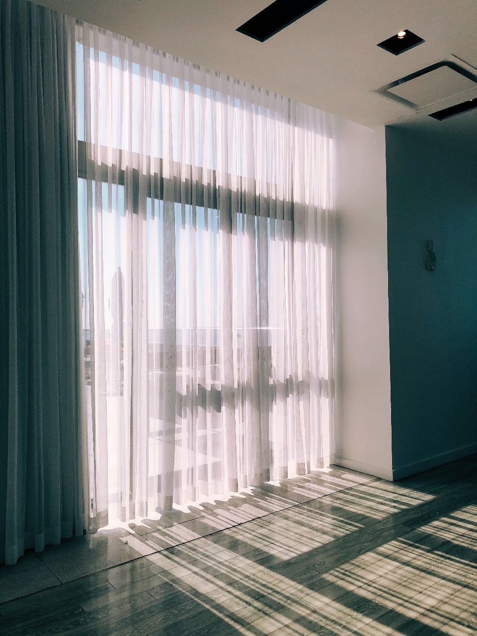 White sheer curtains in a sunlit living room