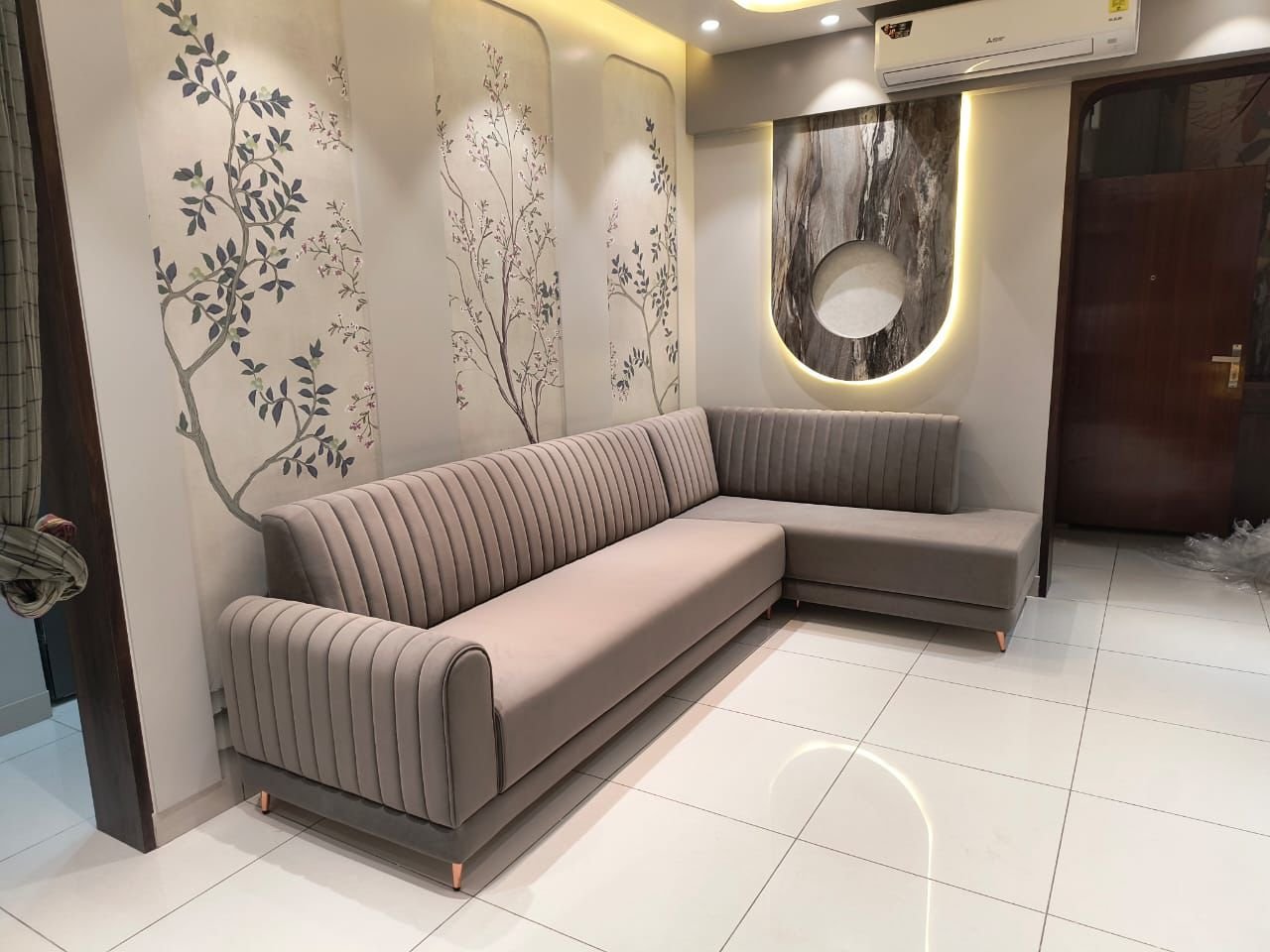 Grey sectional sofa against a chinoiserie wall