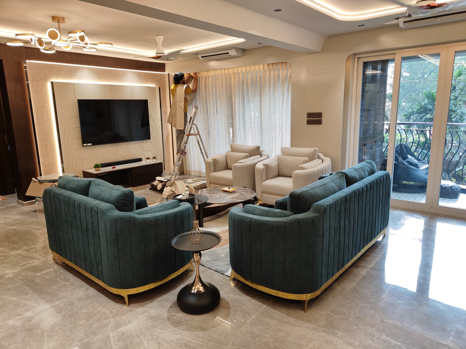 Teal velvet channel-tufted sofas with cream armchairs